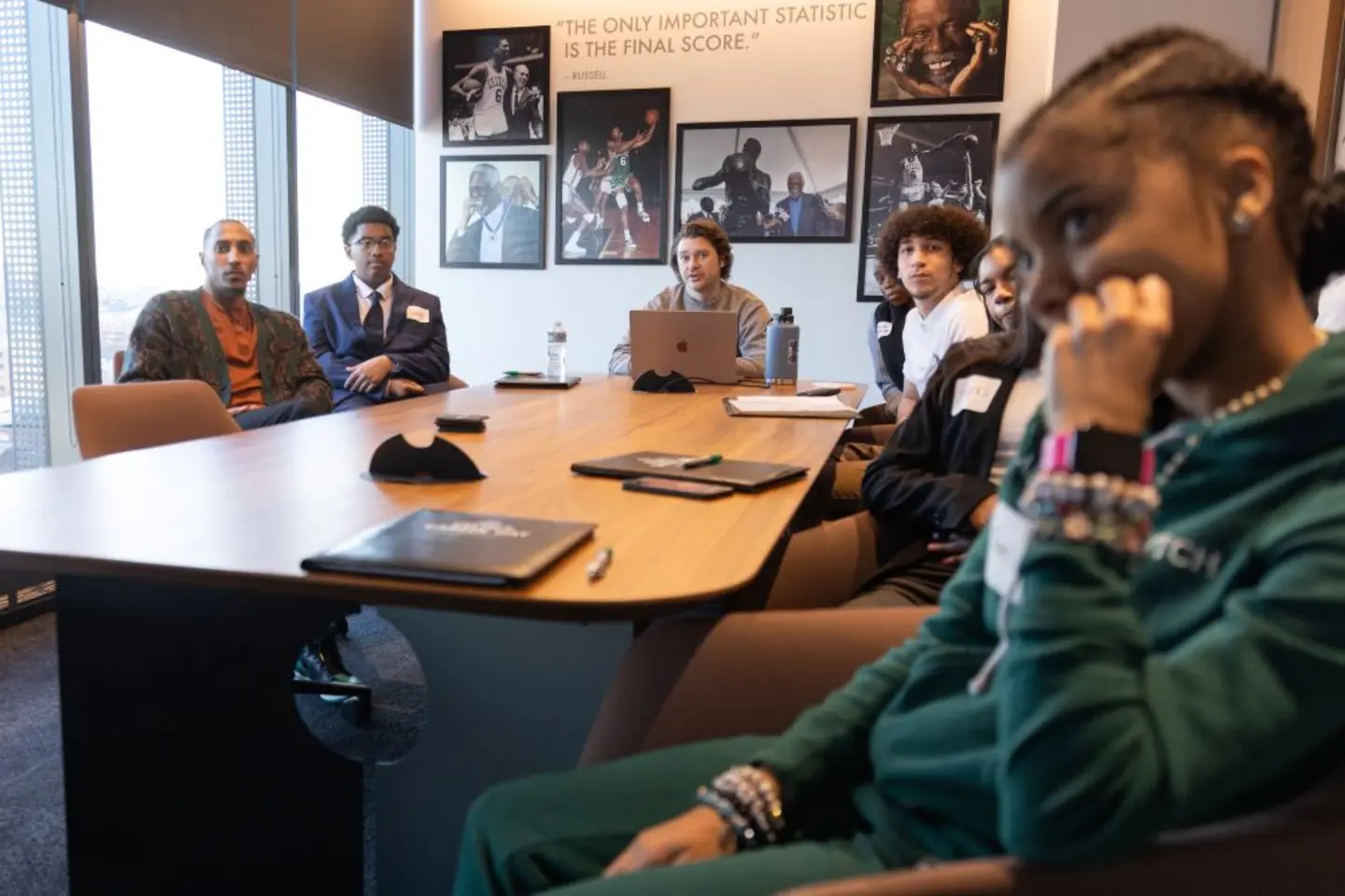 Participants sitting at a table listening to presenter at Celtics Career Day presented by Bentley University