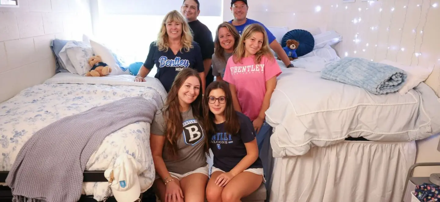 students and families posing in residence hall room