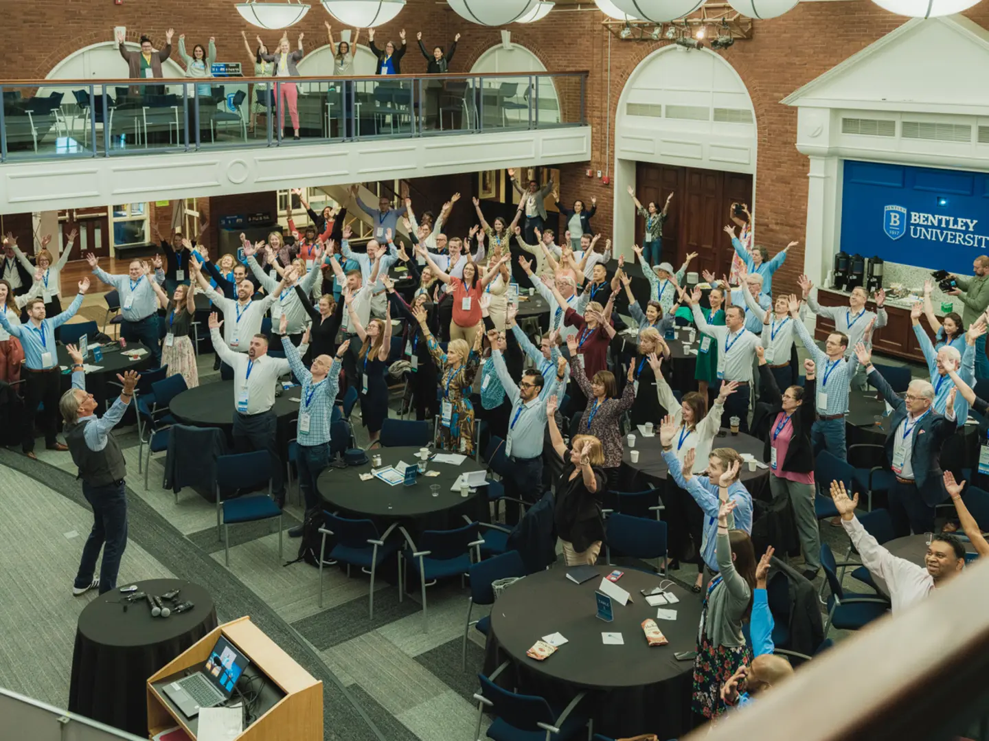 Conference attendees participating in a keynote session