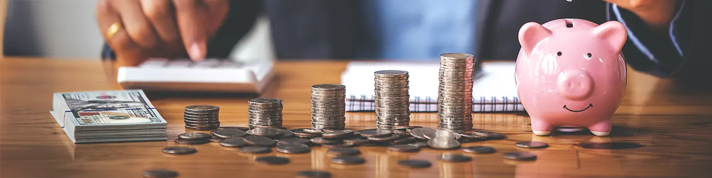 businessman holding a coin in a piggy bank On a table in the morning sun. Money Saving Ideas for Financial Accounting