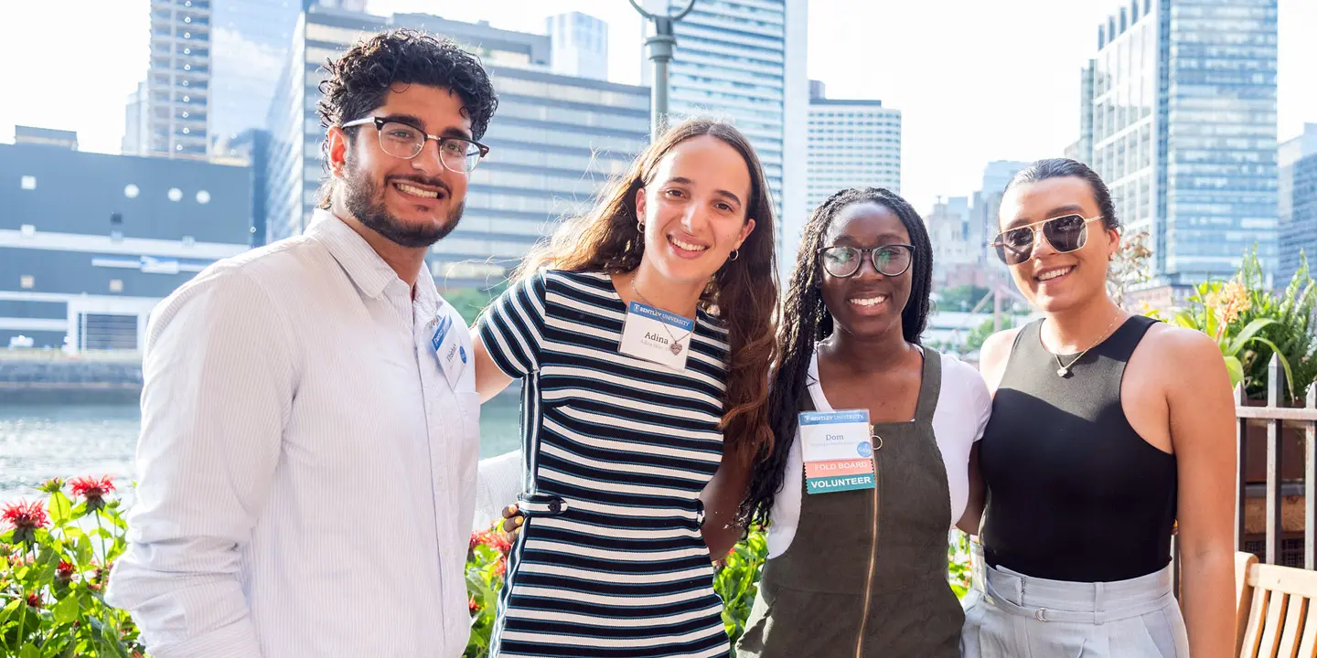 group of alumni in front of sky scrapers