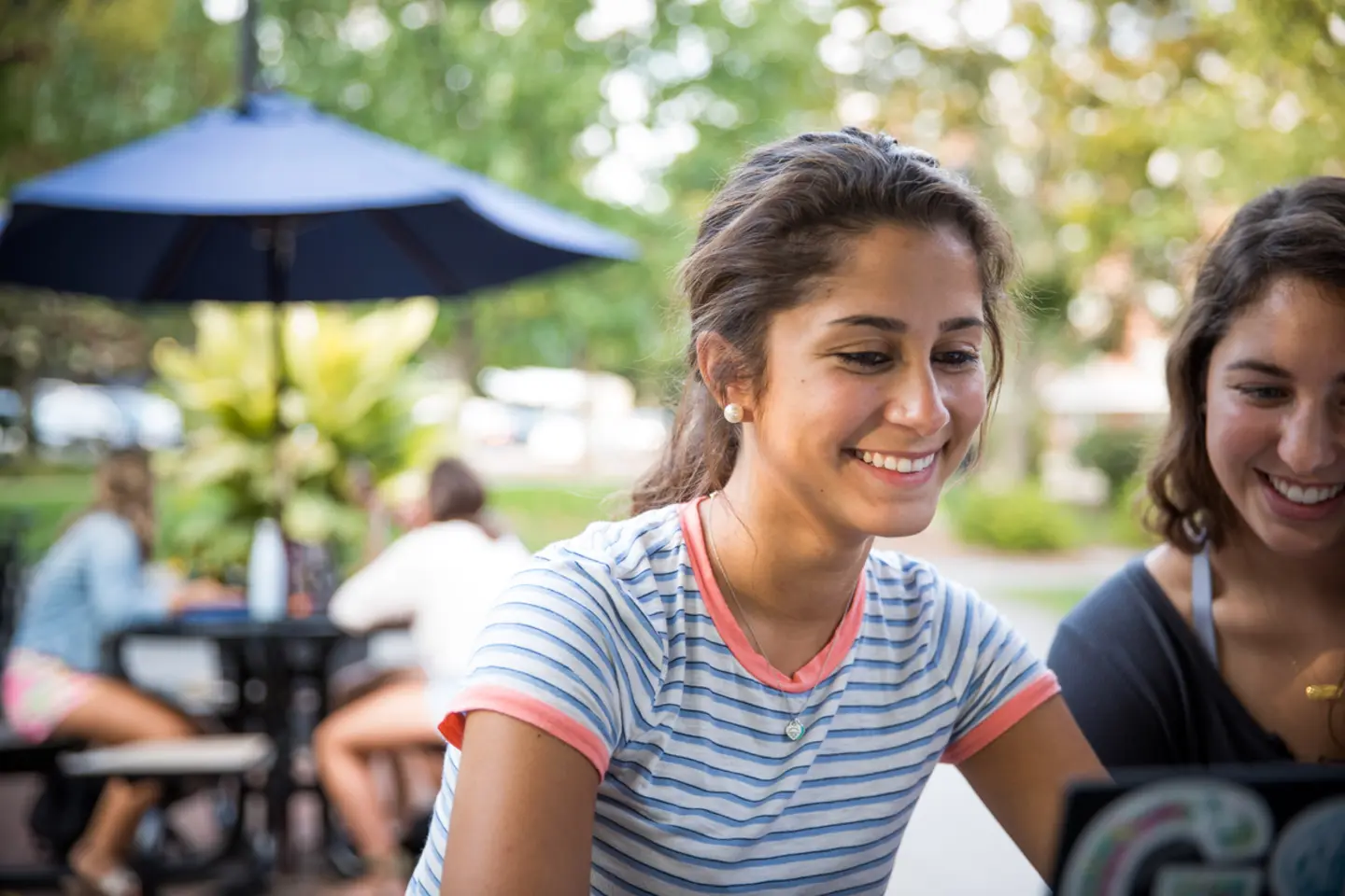 women sitting at laptop