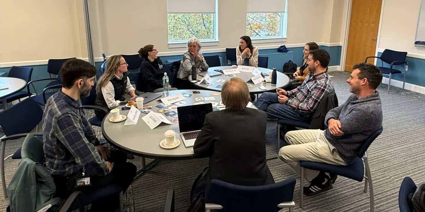 faculty and our team collaborating around a table
