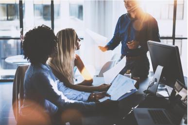 Three people meeting about accounting