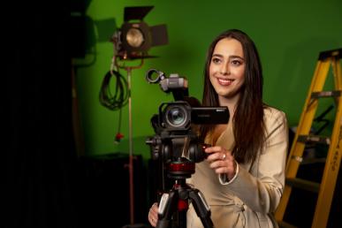 Bentley student Lindsay Toia with hand on video camera