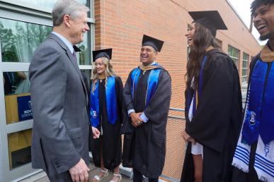 NCAA President Charlie Baker talks with Bentley Class of 2023 graduates