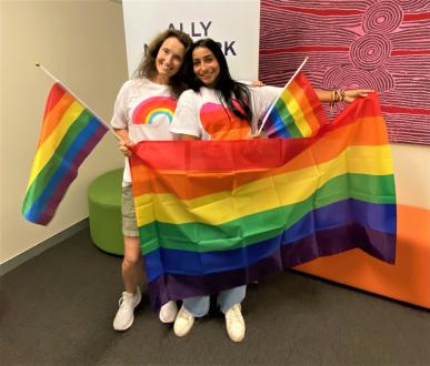Bentley alumna Amy Kenworthy and Teresa Vielma ’23 hold rainbow flags to show their support for Bond University's LGBTQ+ community.