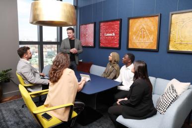Kevin Gillis MBA ’93, partner and COO of Third Rock Ventures, speaks with five Bentley students during their visit to the company's Boston headquarters.